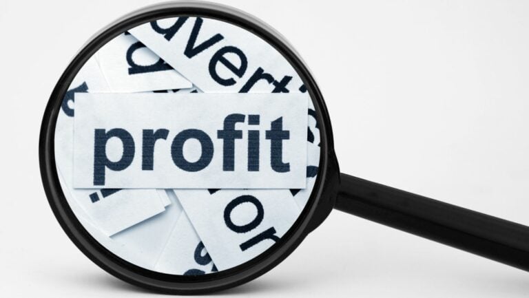 What are the profit strategies: a magnifying glass over a paper labeled profit.