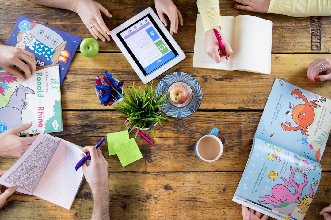 Photo by Twinkl a group of people sitting around a wooden table